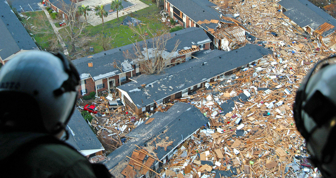 U.S. Navy air crewmen survey the damage from hurricane Katrina